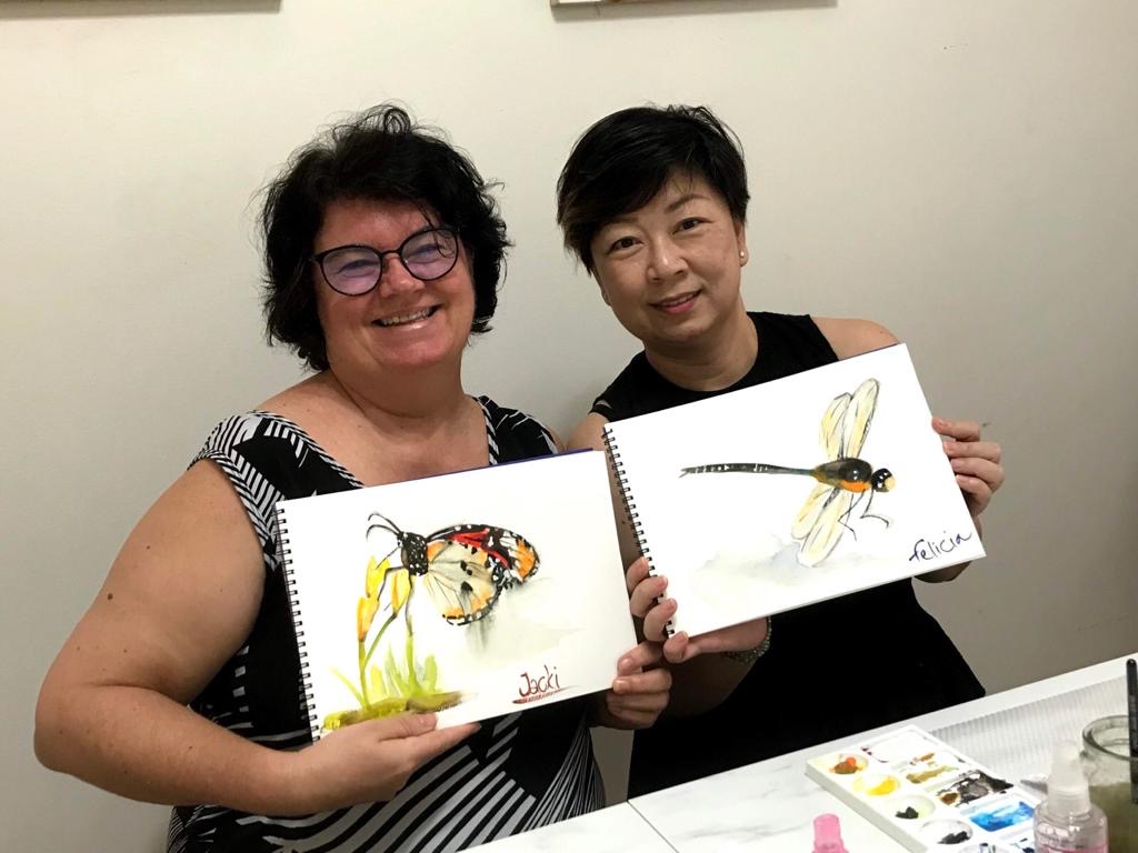 Two of Rie's students with their first and second paintings